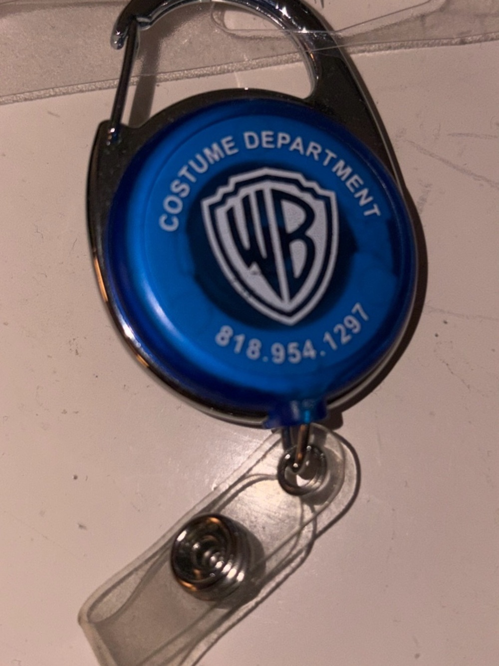 Blue Warner Bros. Logo Retractable Badge Reel and tape measurement